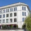 Weißes Geschäftshaus mit Restaurant-Terrasse und breiter Freitreppe
