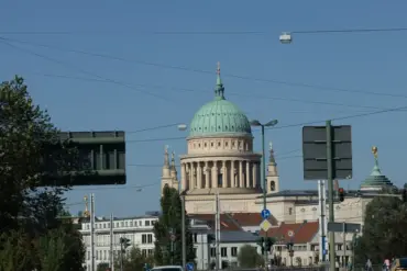 Blick über eine Hauptstraße auf die Kuppel der Nikolaikirche
